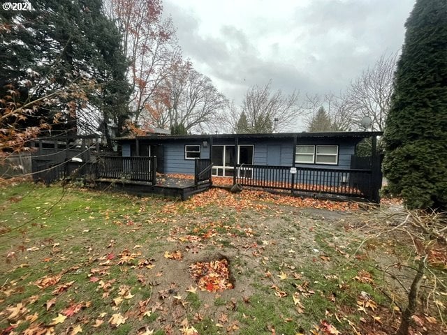 view of front facade featuring a deck and a front lawn