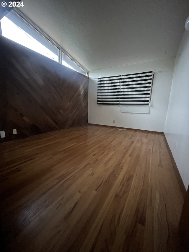 empty room with hardwood / wood-style flooring