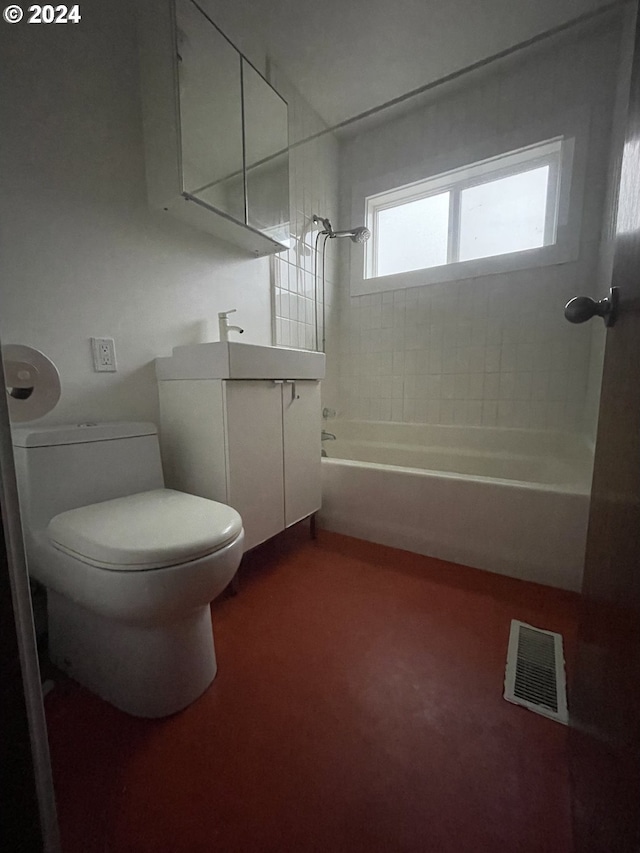 full bathroom featuring toilet, vanity, and tiled shower / bath