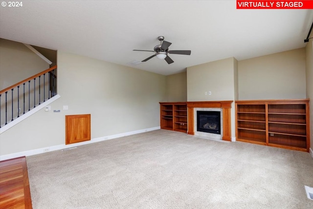 unfurnished living room with ceiling fan and carpet floors