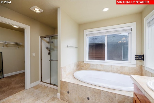 bathroom with vanity, tile patterned flooring, and shower with separate bathtub