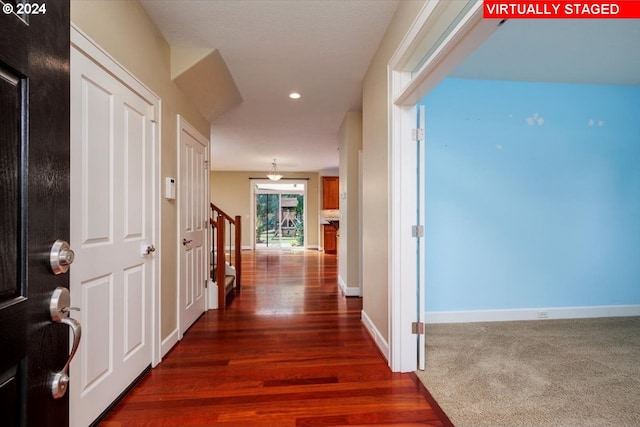 corridor with dark hardwood / wood-style flooring