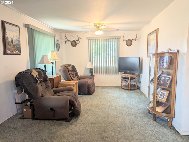 carpeted living room featuring ceiling fan