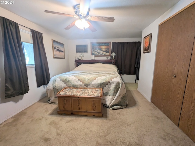 bedroom featuring light colored carpet, a closet, and ceiling fan