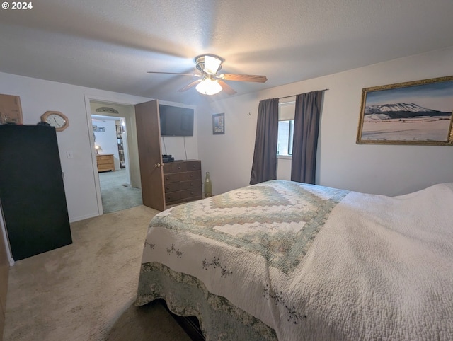 bedroom with carpet, a textured ceiling, and ceiling fan