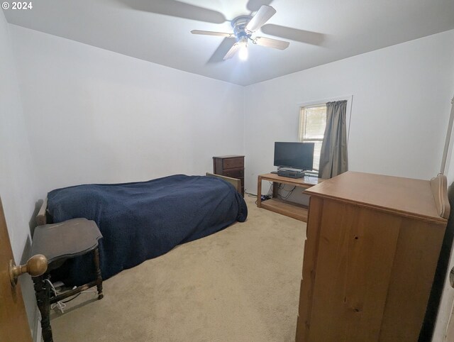 bedroom with light colored carpet and ceiling fan