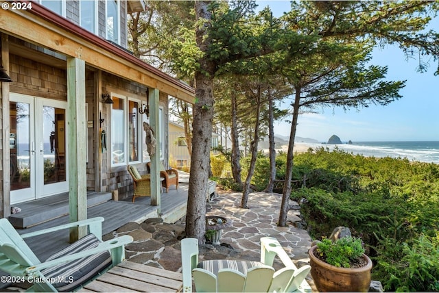 view of patio / terrace with french doors and a deck with water view