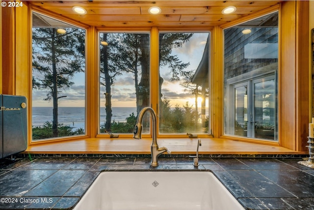 details featuring wood ceiling, sink, and a water view