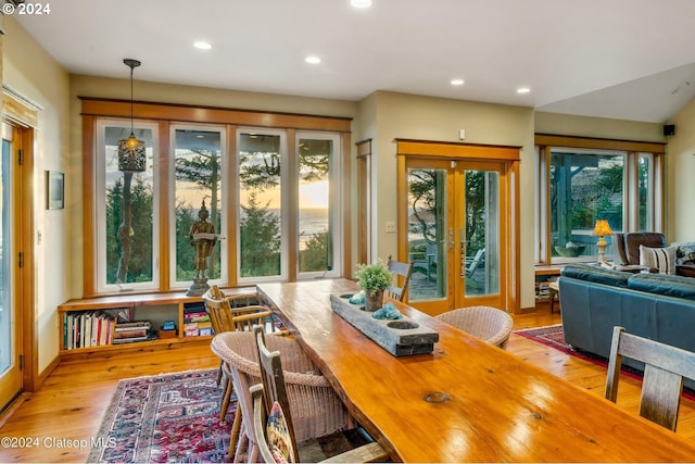 dining area featuring a wealth of natural light, light wood-type flooring, and french doors