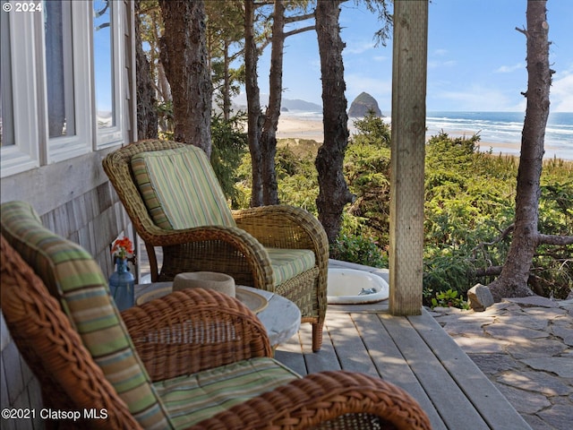 wooden terrace featuring a water view