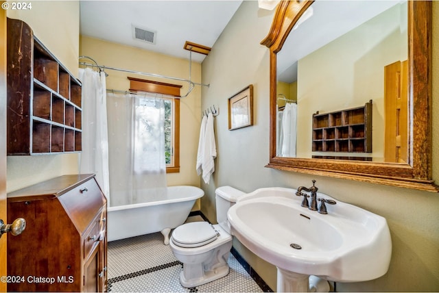 full bathroom featuring tile patterned floors, toilet, separate shower and tub, and sink