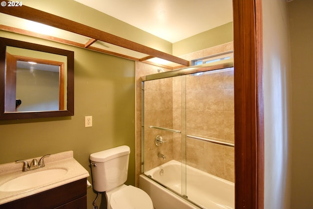 full bathroom featuring bath / shower combo with glass door, vanity, and toilet