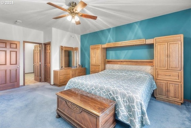 bedroom featuring light carpet and ceiling fan