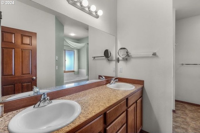 bathroom with dual bowl vanity and tile patterned flooring