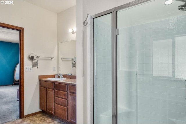 bathroom with vanity and a shower with door