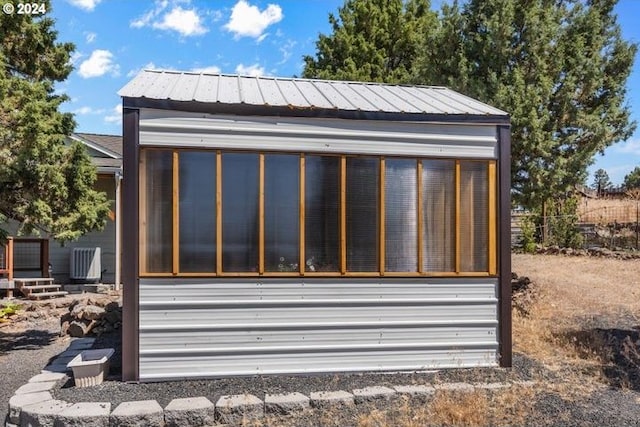 view of outbuilding with a sunroom