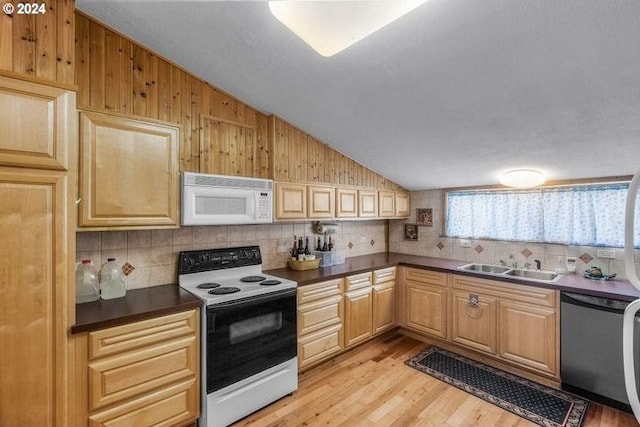 kitchen featuring light wood-type flooring, white appliances, sink, and vaulted ceiling