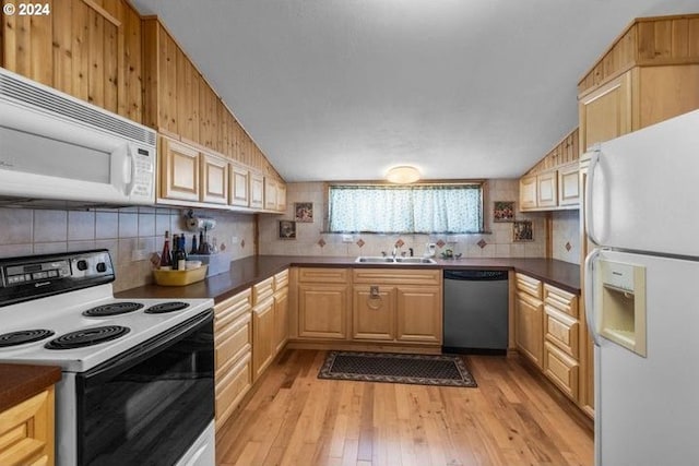 kitchen with white appliances, light wood-type flooring, lofted ceiling, and sink