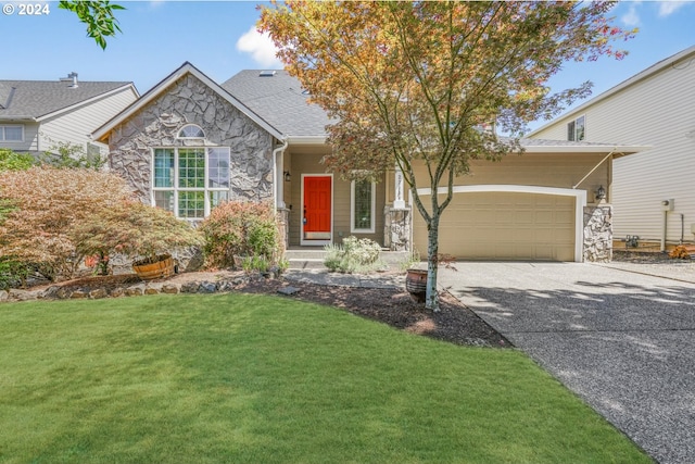 view of front of home featuring a garage and a front lawn