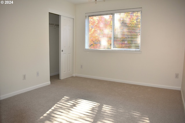 unfurnished bedroom featuring a closet and carpet