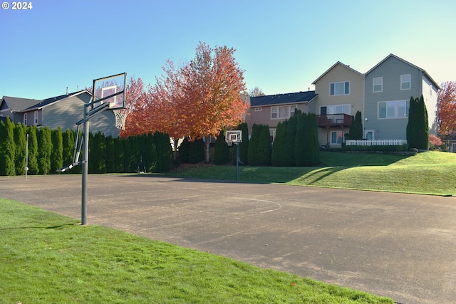 view of basketball court with a lawn