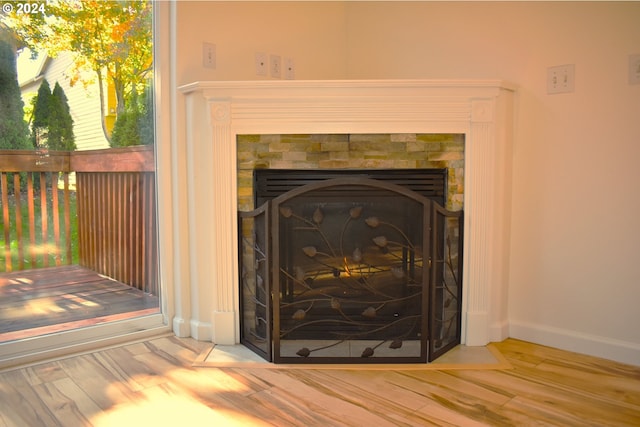 room details with hardwood / wood-style floors and a fireplace