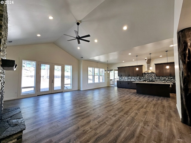 unfurnished living room featuring high vaulted ceiling, hardwood / wood-style floors, and a wealth of natural light