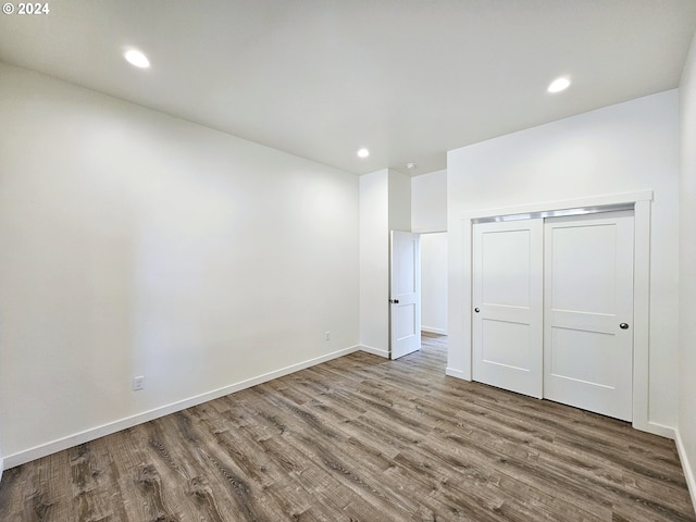 unfurnished bedroom featuring wood-type flooring and a closet