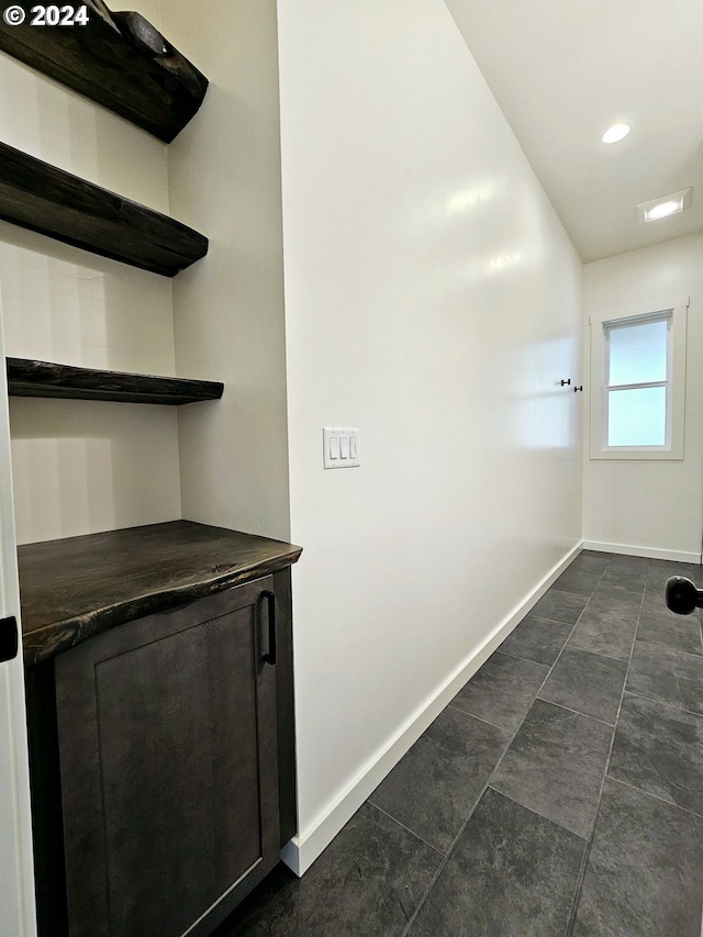 interior space featuring dark tile patterned flooring