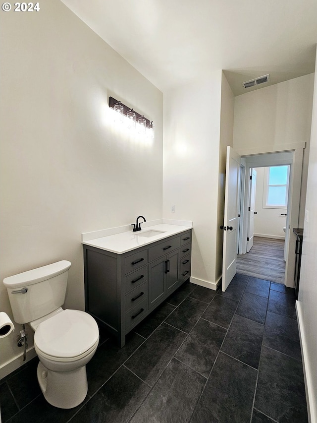 bathroom with tile patterned floors, vanity, and toilet