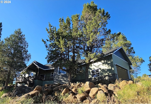 view of home's exterior with a balcony and a garage