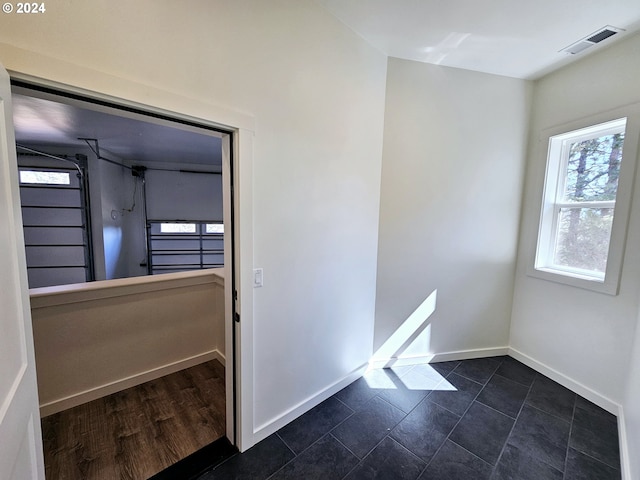 spare room with dark hardwood / wood-style floors