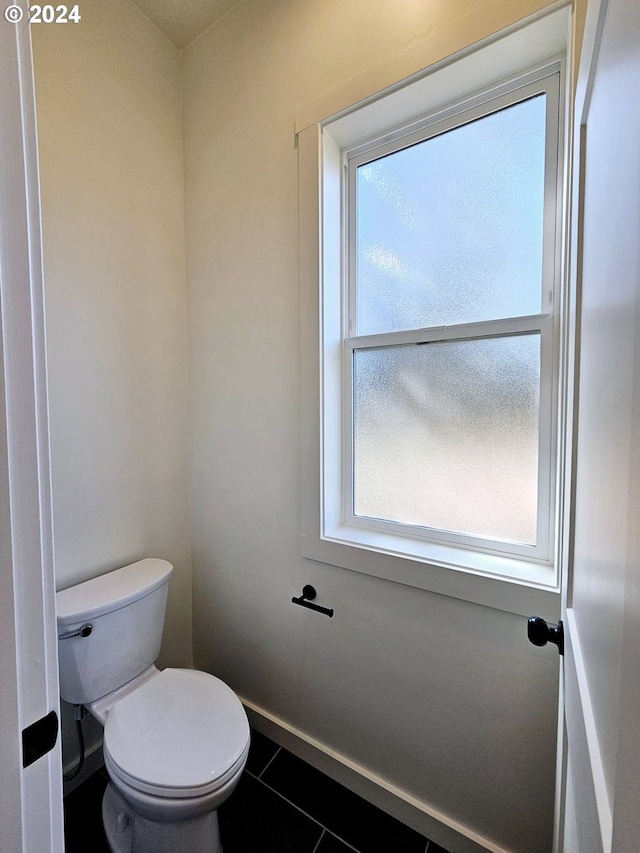 bathroom featuring toilet and tile patterned flooring