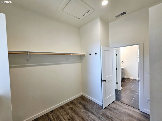 spacious closet featuring dark hardwood / wood-style floors