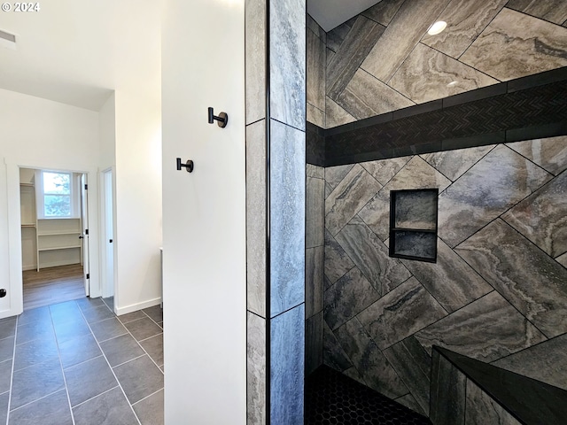 bathroom featuring tile patterned floors and tiled shower