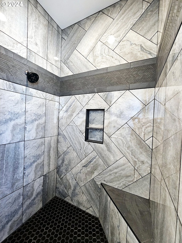 bathroom with tiled shower