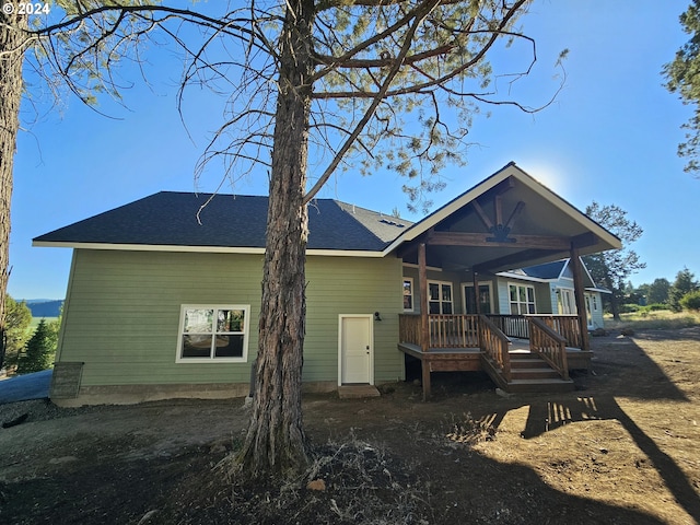 rear view of property featuring ceiling fan