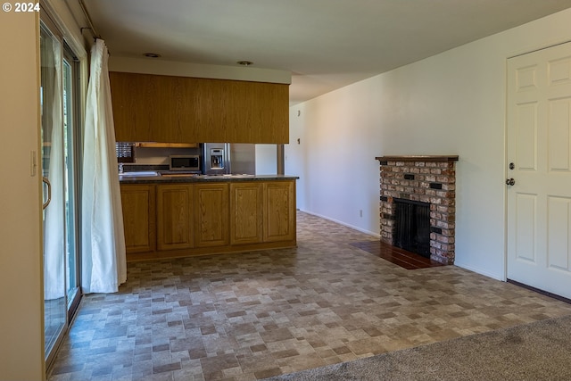 kitchen featuring a fireplace and appliances with stainless steel finishes