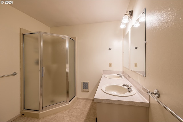 bathroom featuring tile patterned flooring, vanity, and a shower with shower door