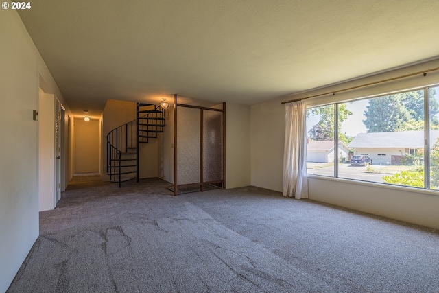 unfurnished living room featuring carpet flooring