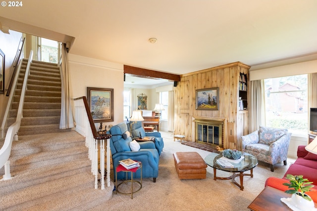 3465 Avalon Dr, Hood River, OR 97031 - carpeted living area with wood walls, a glass covered fireplace, stairs, and ornamental molding