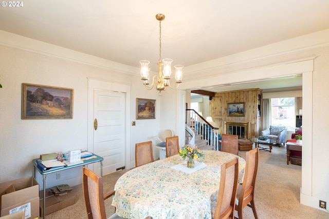 carpeted dining area featuring a notable chandelier