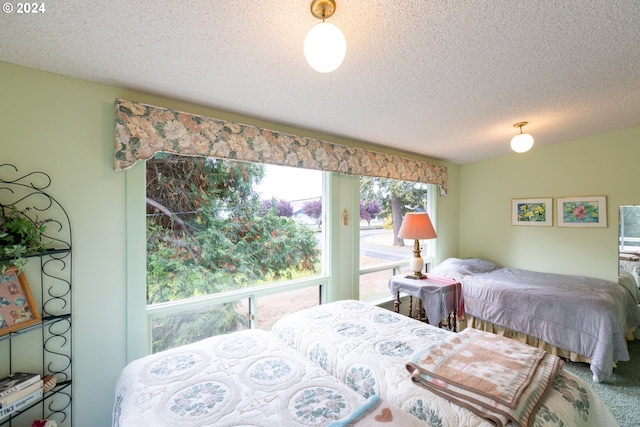 bedroom featuring a textured ceiling and carpet floors