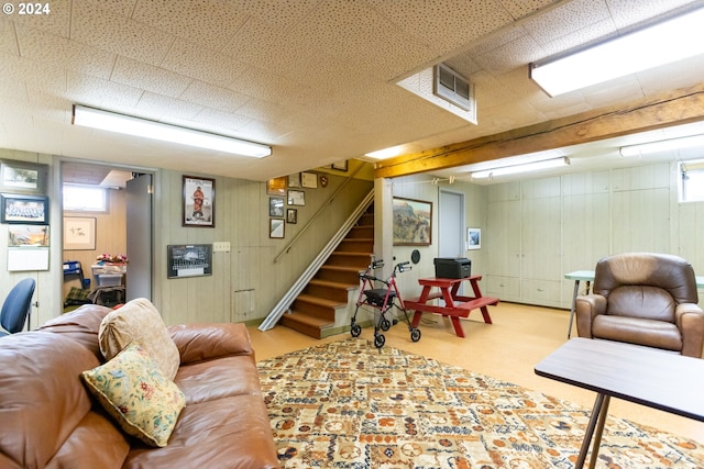3465 Avalon Dr, Hood River, OR 97031 - living area featuring wood walls, stairs, visible vents, and carpet
