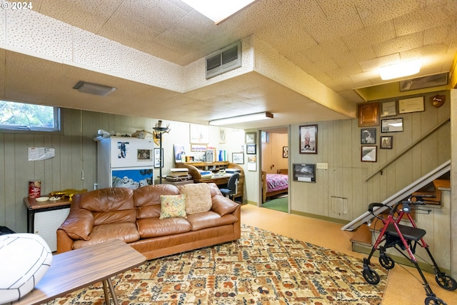 living room with carpet flooring and wooden walls