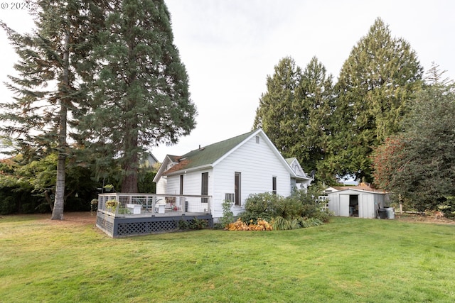 3465 Avalon Dr, Hood River, OR 97031 - rear view of house featuring a wooden deck, a storage unit, a lawn, and an outbuilding