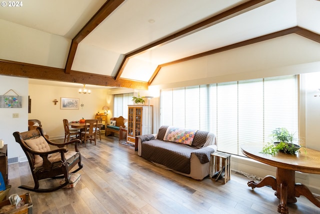 living room with vaulted ceiling with beams, a notable chandelier, and wood-type flooring