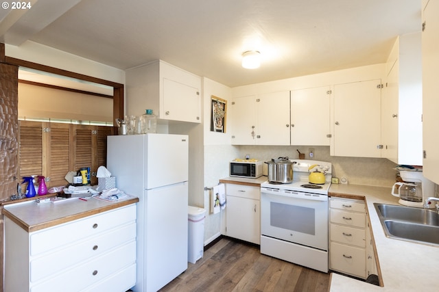 kitchen with white appliances, tasteful backsplash, sink, dark hardwood / wood-style flooring, and white cabinets