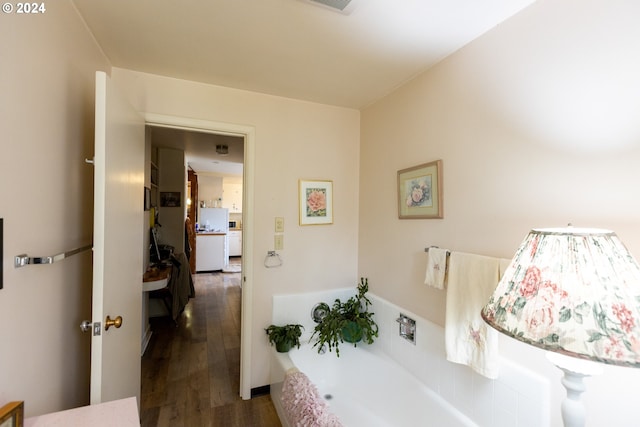 bathroom featuring hardwood / wood-style flooring and a bathing tub