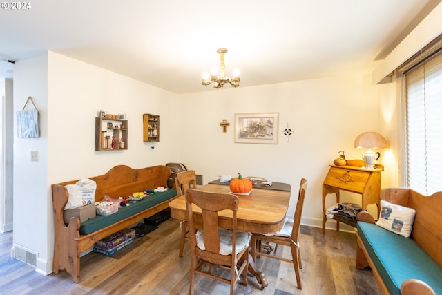 3465 Avalon Dr, Hood River, OR 97031 - dining area with wood finished floors, visible vents, baseboards, and a notable chandelier